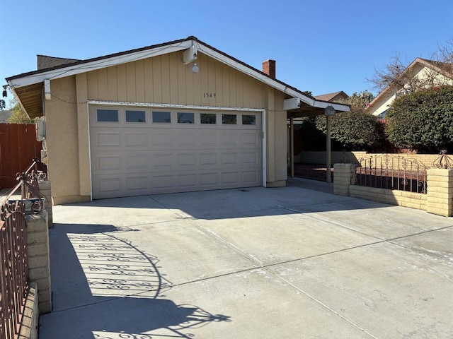 view of front facade featuring concrete driveway and fence