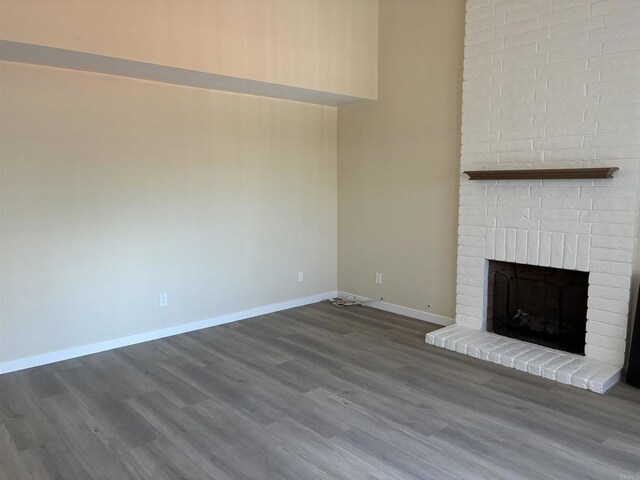 1549 Grand Teton Ct, Chula Vista, CA 91911 - unfurnished living room featuring a brick fireplace and dark wood finished floors