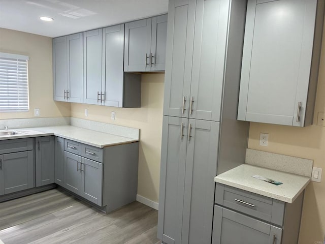 1549 Grand Teton Ct, Chula Vista, CA 91911 - kitchen featuring gray cabinetry, light wood-style floors, light countertops, and recessed lighting