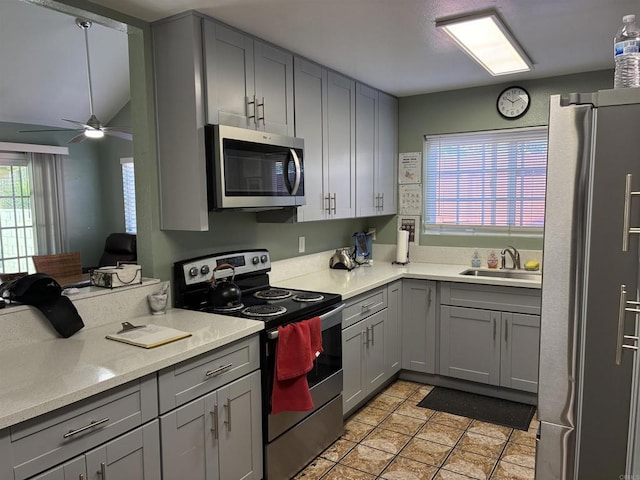 1549 Grand Teton Ct, Chula Vista, CA 91911 - kitchen featuring appliances with stainless steel finishes, gray cabinetry, ceiling fan, light countertops, and light tile patterned floors
