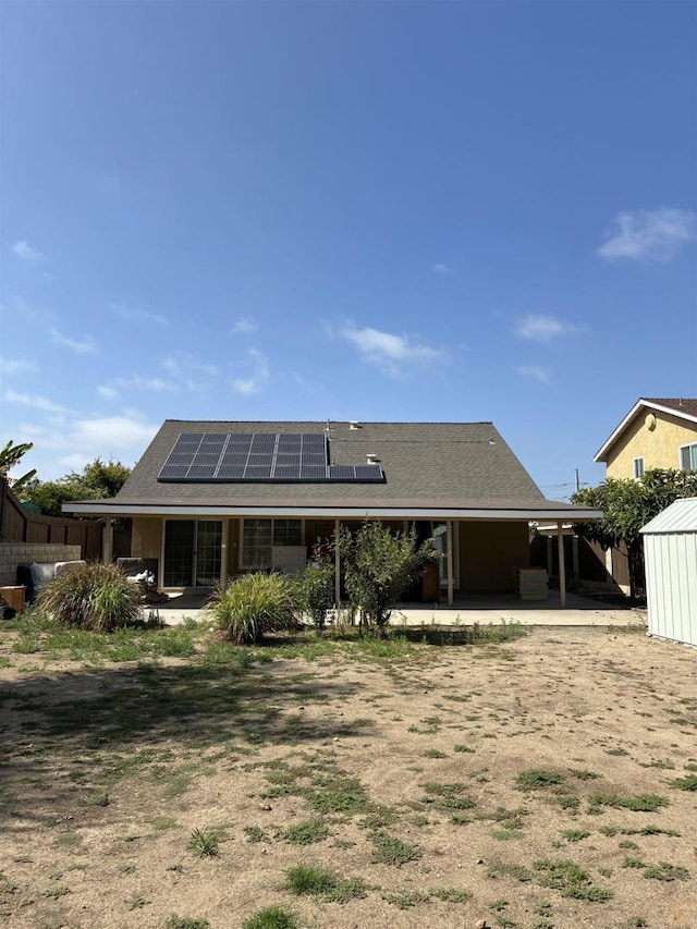1549 Grand Teton Ct, Chula Vista, CA 91911 - back of property featuring solar panels, a storage unit, and a patio
