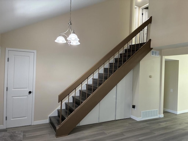 1549 Grand Teton Ct, Chula Vista, CA 91911 - stairway featuring wood finished floors, a chandelier, and high vaulted ceiling