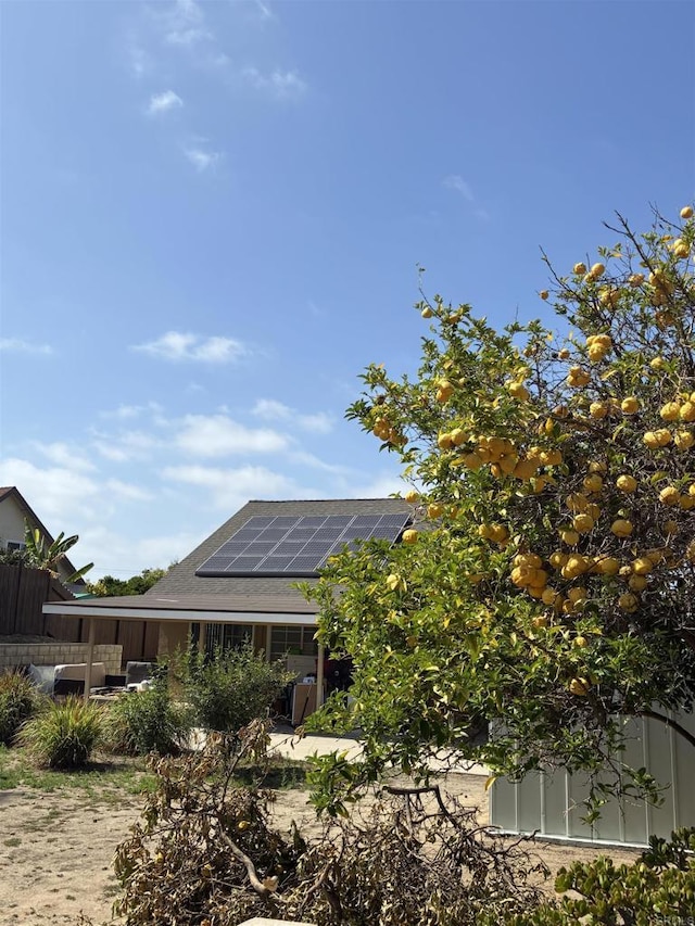 1549 Grand Teton Ct, Chula Vista, CA 91911 - rear view of property with roof mounted solar panels and roof with shingles