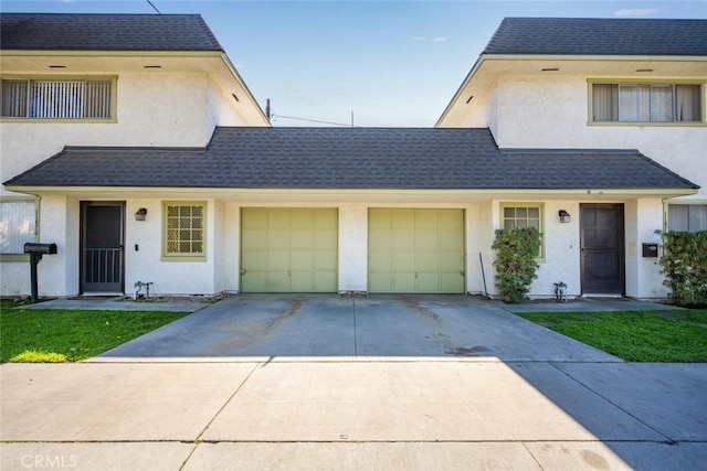 view of property with a shingled roof, concrete driveway, a garage, and stucco siding