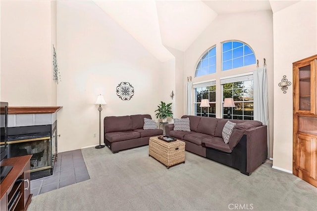 living room featuring a fireplace, high vaulted ceiling, and carpet floors