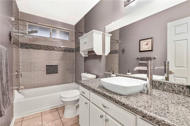 bathroom featuring tile patterned floors, toilet, vanity, and shower / tub combination