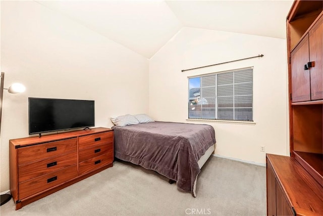 bedroom featuring lofted ceiling and light colored carpet