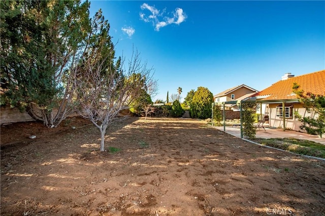 view of yard with a patio and fence