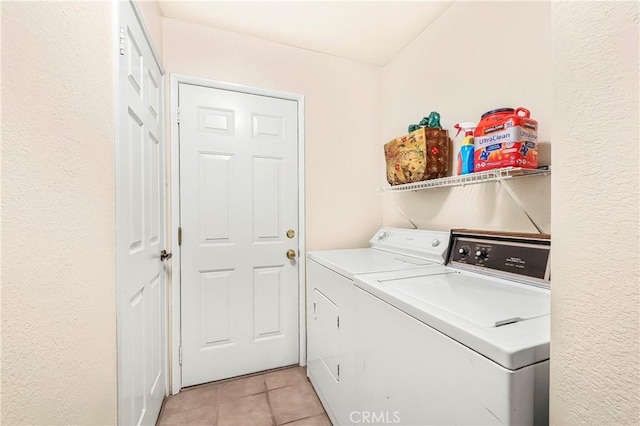 laundry area featuring light tile patterned flooring, laundry area, and washer and dryer