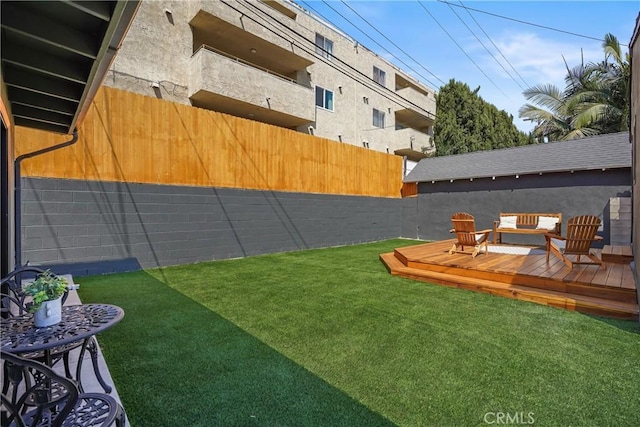 view of yard featuring a deck and fence