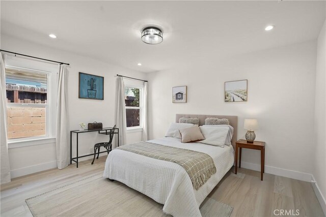 bedroom with light wood-style flooring, recessed lighting, and baseboards