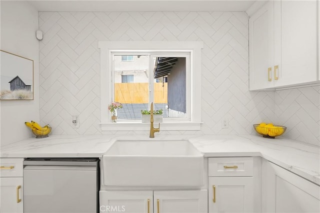 kitchen with light stone counters, backsplash, dishwasher, and white cabinets