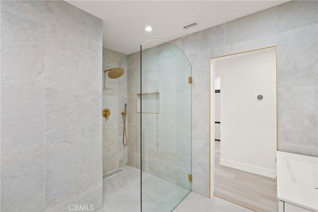 bathroom featuring visible vents and walk in shower