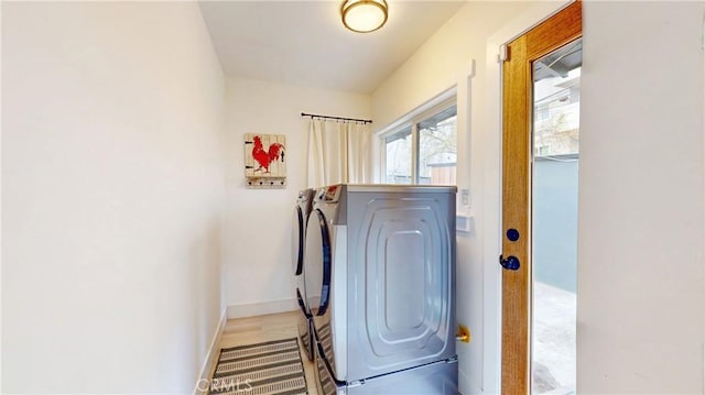 washroom with washer and clothes dryer, laundry area, and baseboards