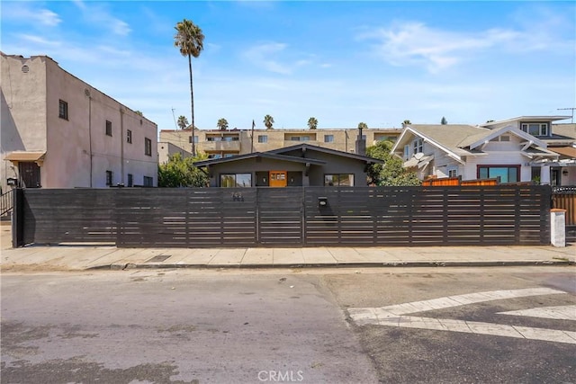 view of front of home featuring a gate, a residential view, and a fenced front yard