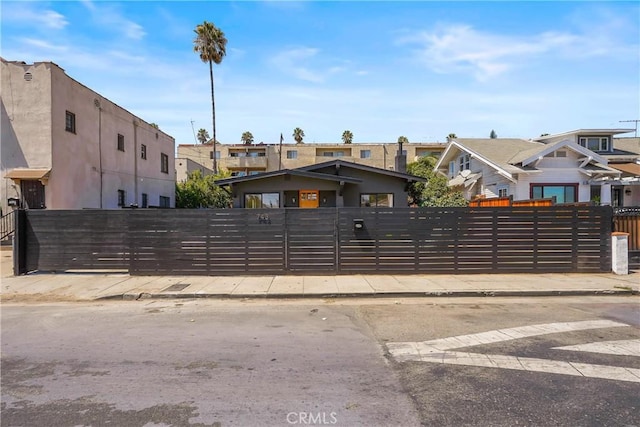 view of gate featuring a fenced front yard and a residential view