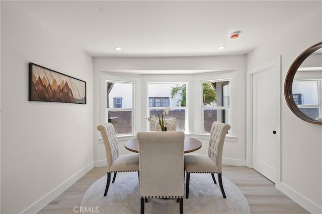 dining room featuring recessed lighting, light wood-style flooring, and baseboards