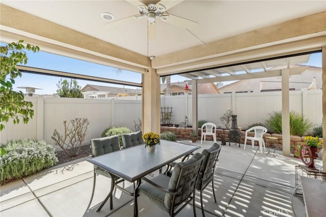 view of patio / terrace with a fenced backyard, outdoor dining space, and a ceiling fan