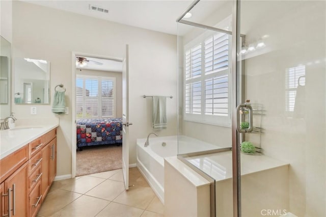 ensuite bathroom with visible vents, a shower stall, a garden tub, tile patterned floors, and vanity