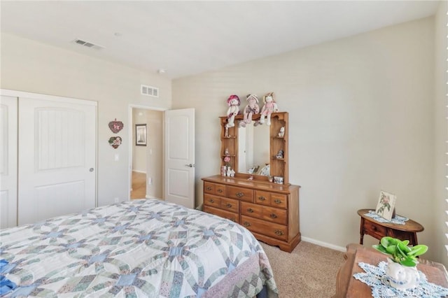 carpeted bedroom featuring a closet and visible vents