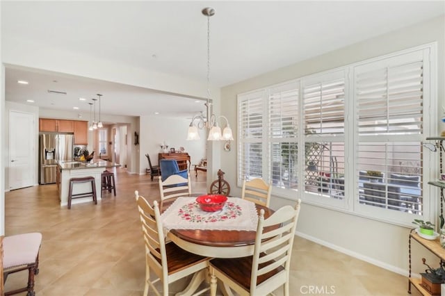 dining area with light tile patterned floors, recessed lighting, baseboards, and an inviting chandelier