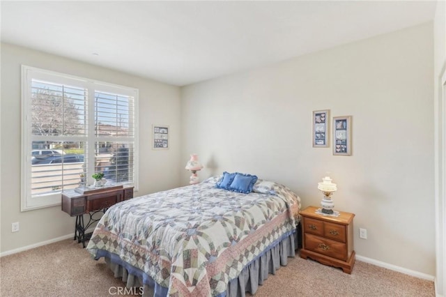 carpeted bedroom featuring baseboards