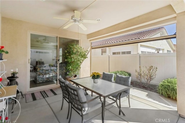 view of patio / terrace with outdoor dining area, ceiling fan, and fence