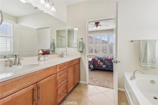 bathroom featuring tile patterned floors, double vanity, ceiling fan, and a sink