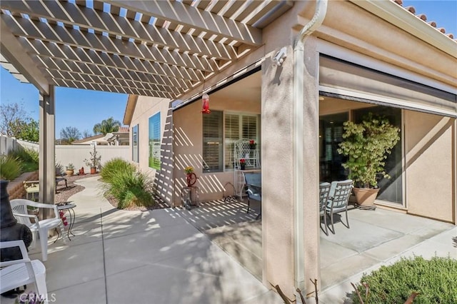 view of patio / terrace featuring outdoor dining area, a pergola, and fence