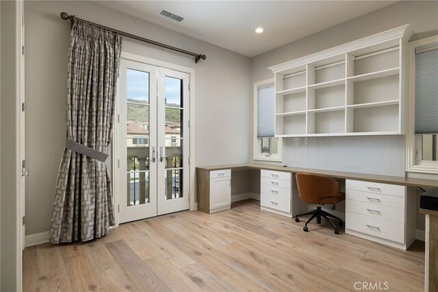 unfurnished office featuring visible vents, light wood finished floors, built in study area, recessed lighting, and french doors