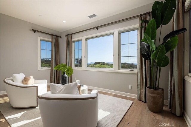 sitting room with visible vents, recessed lighting, light wood-type flooring, and baseboards