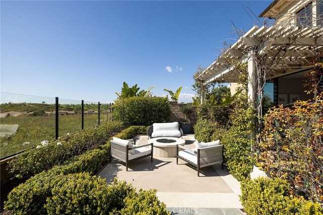 view of patio with an outdoor living space with a fire pit, a fenced backyard, and a pergola