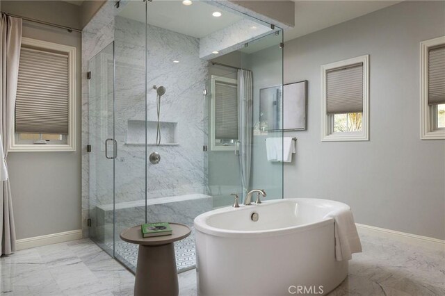 full bath featuring baseboards, marble finish floor, and a stall shower