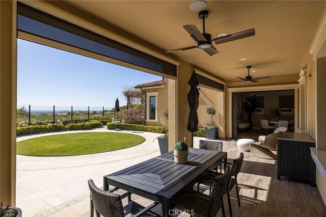 view of patio / terrace featuring outdoor dining area, a ceiling fan, and fence