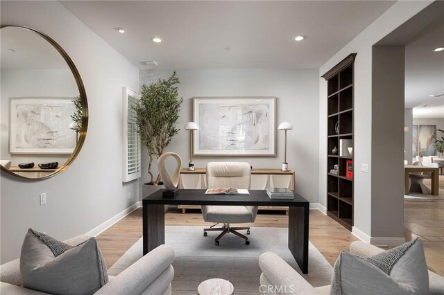 office area with recessed lighting, light wood-style flooring, and baseboards