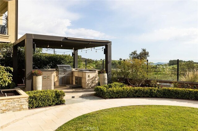 view of patio featuring area for grilling and an outdoor kitchen