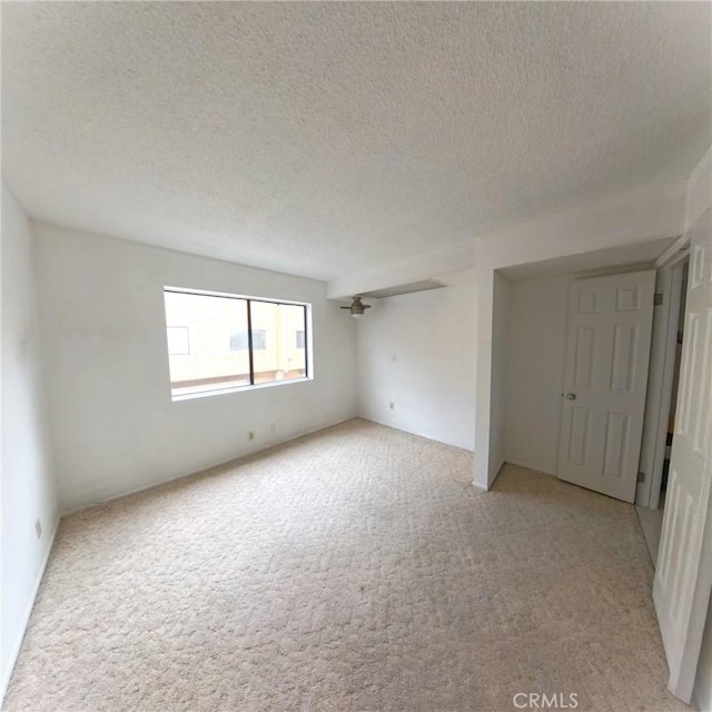 504 Jay Ct, Montebello, CA 90640 - unfurnished bedroom featuring light carpet and a textured ceiling