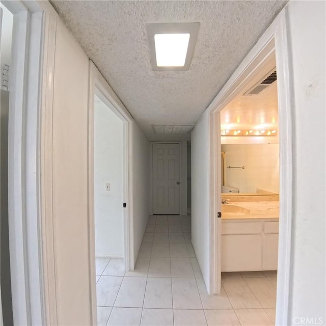 504 Jay Ct, Montebello, CA 90640 - hallway with a textured ceiling and light tile patterned floors