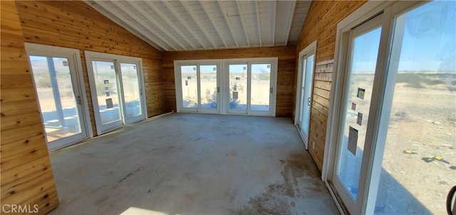 unfurnished sunroom featuring vaulted ceiling