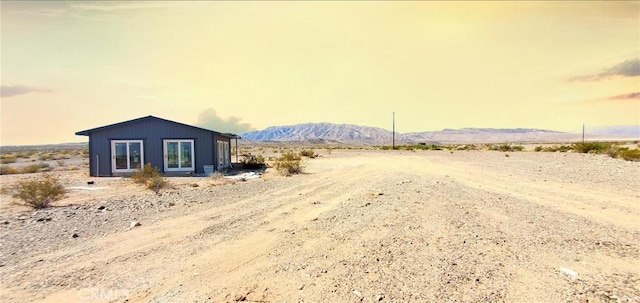 view of yard with a mountain view and view of desert