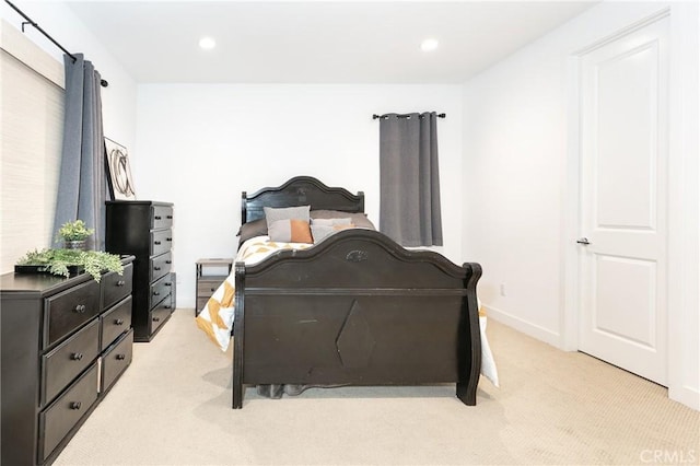 bedroom with recessed lighting, baseboards, and light carpet