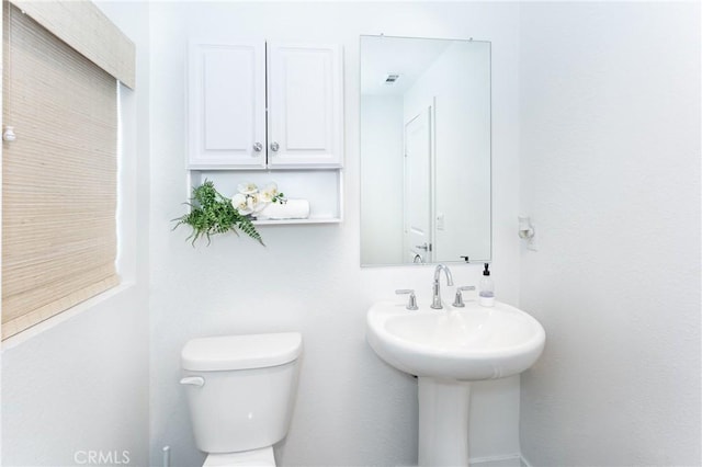 bathroom with visible vents and toilet