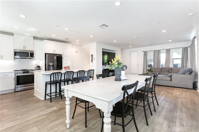 dining room with recessed lighting, light wood-style floors, and visible vents