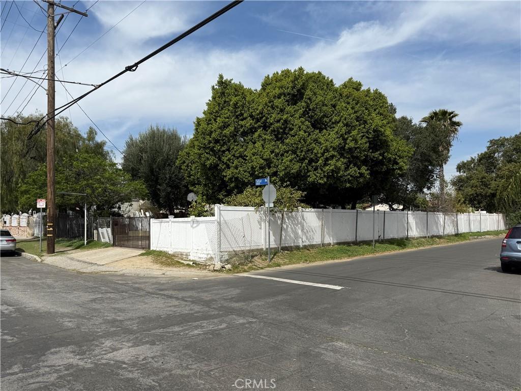 uncovered parking lot featuring fence