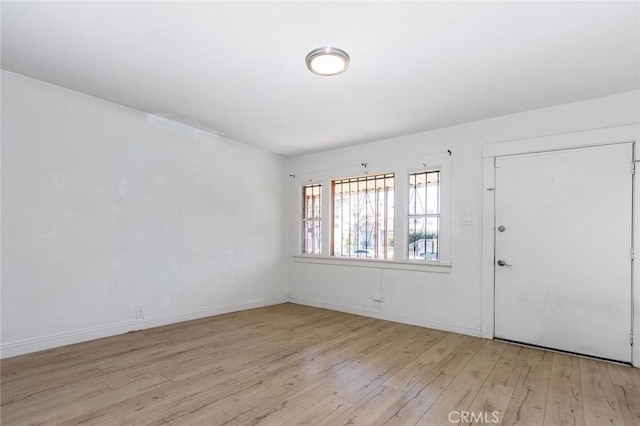 foyer entrance featuring baseboards and hardwood / wood-style flooring