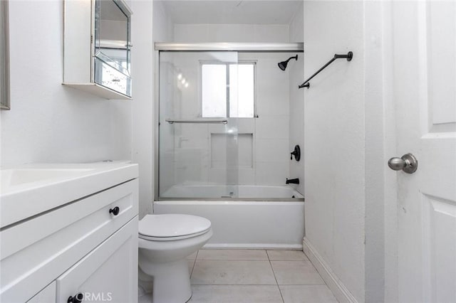 bathroom featuring tile patterned floors, toilet, vanity, and bath / shower combo with glass door