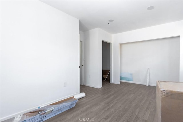 interior space featuring a closet, baseboards, and wood finished floors