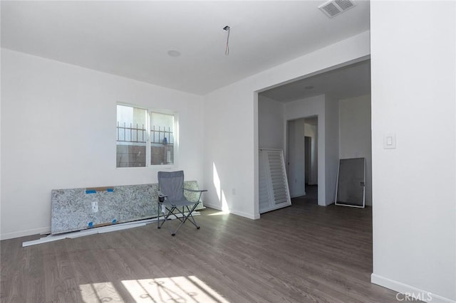 interior space with visible vents, baseboards, and wood finished floors