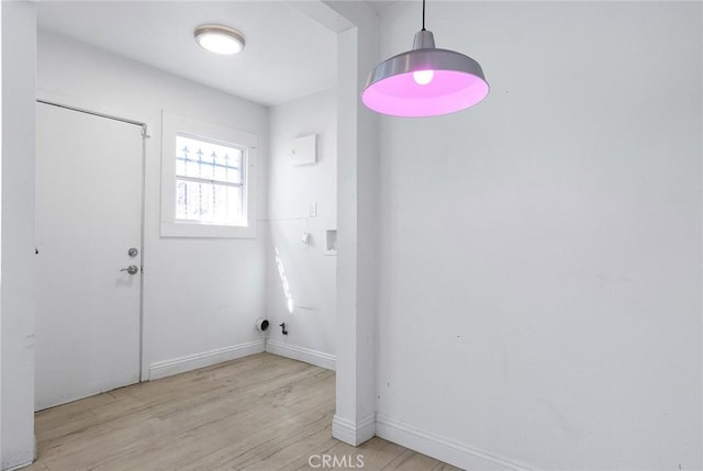 washroom with baseboards and light wood-type flooring