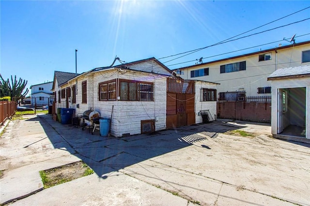 back of house featuring fence